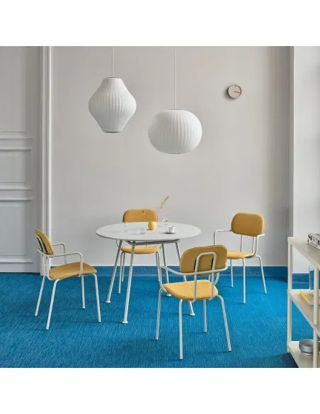 Table ronde blanche entourée de chaises jaunes