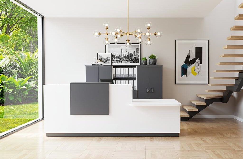 Une banque d’accueil professionnelle moderne blanche et gris foncé avec un comptoir devant une étagère et des rangements, près